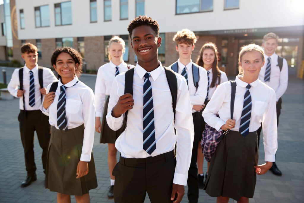 Schüler einer Schule stehen vor deren Schule